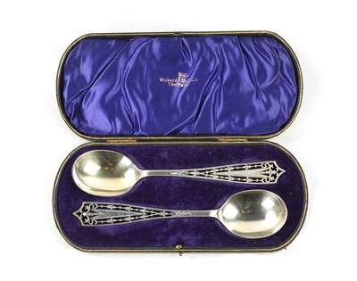 Lot 125 - A CASED PAIR OF PIERCED AND ENGRAVED SILVER SERVING SPOONS