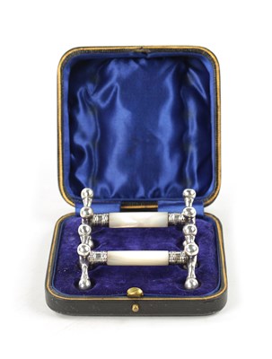 Lot 123 - A PAIR OF CASED SILVER AND MOTHER-OF-PEARL KNIFE RESTS