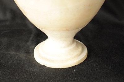Lot 472 - AN EARLY CARVED ALABASTER URN