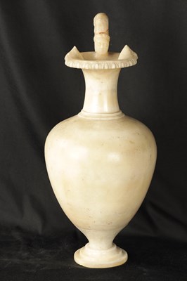 Lot 472 - AN EARLY CARVED ALABASTER URN