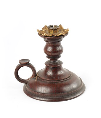 Lot 274 - A 19TH CENTURY TURNED OAK CHAMBERSTICK WITH PETAL SHAPED ORMOLU SCONCE