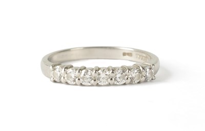 Lot 211 - A 7-STONE DIAMOND AND PLATINUM HALF-ETERNITY RING