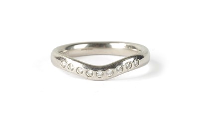 Lot 181 - A TIFFANY & CO 9-STONE DIAMOND AND PLATINUM HERRINGBONE RING