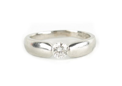 Lot 197 - A 0.33CT TENSION SET DIAMOND AND PLATINUM RING