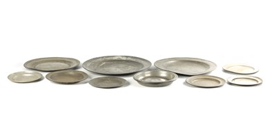 Lot 144 - A COLLECTION OF 18TH CENTURY PEWTER CHARGERS, PLATES AND A SHALLOW DISH