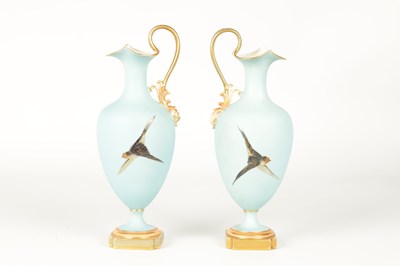 Lot 62 - CHARLES H C. BALDWYN A FINE PAIR OF ROYAL WORCESTER RICHLY GILT AND SKY BLUE GROUND OVOID EWERS WITH SCROLL HANDLES