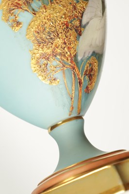 Lot 62 - CHARLES H C. BALDWYN A FINE PAIR OF ROYAL WORCESTER RICHLY GILT AND SKY BLUE GROUND OVOID EWERS WITH SCROLL HANDLES