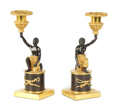 Lot 403 - A PAIR OF FRENCH EMPIRE BRONZE AND ORMOLU BLACKAMOOR CANDLESTICKS