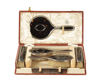 Lot 280 - AN EARLY 20TH CENTURY SILVER AND TORTOISESHELL SIX PIECE CASED DRESSING TABLE SET