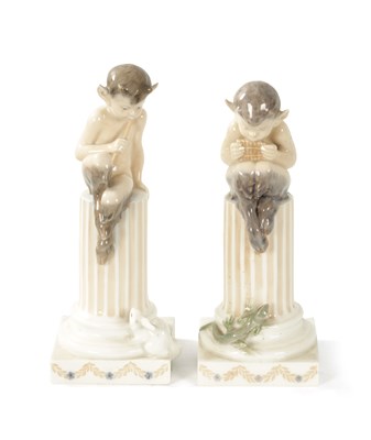 Lot 415 - A PAIR OF EARLY 20TH CENTURY ROYAL COPENHAGEN FIGURES MODELLED AS FAUNS ON COLUMNS WITH A RABBIT AND A LIZARD