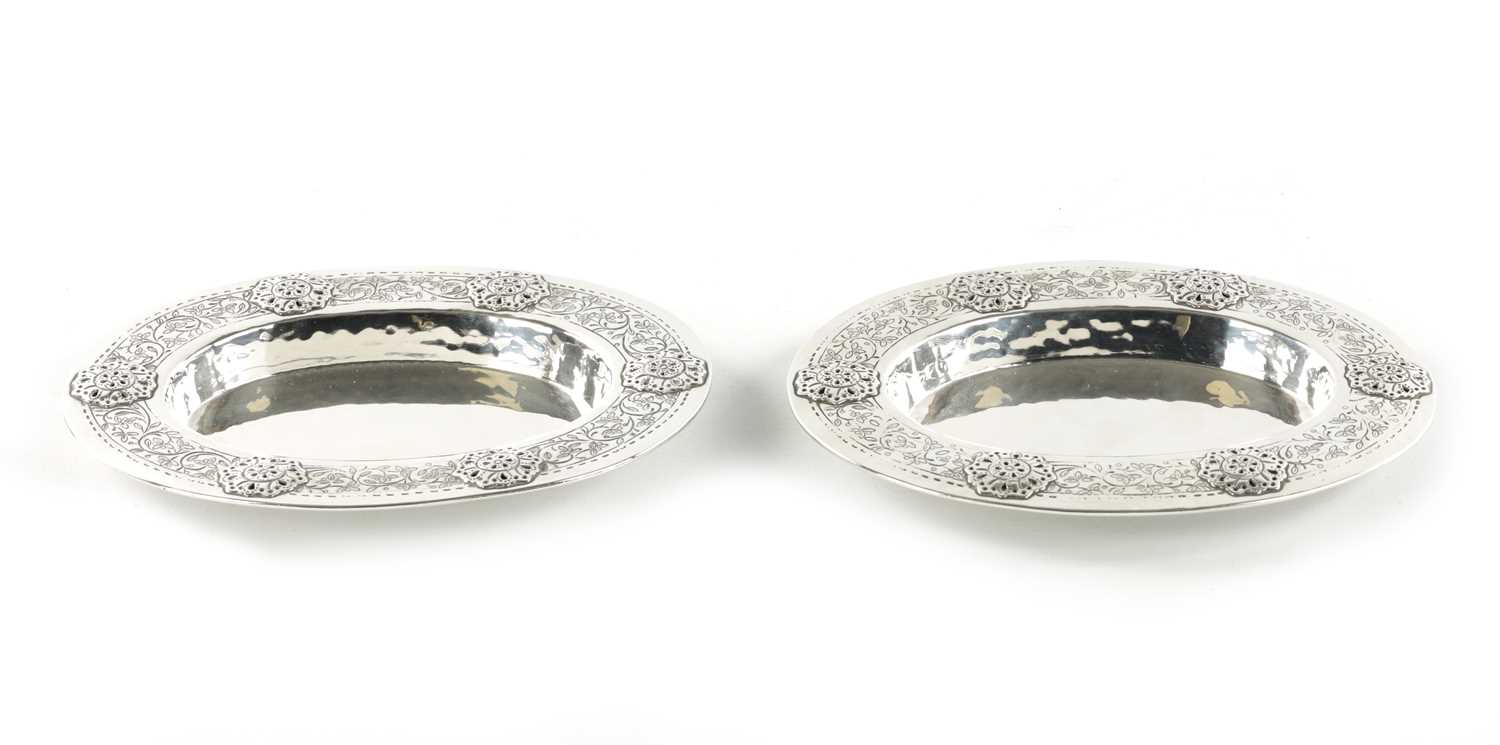 Lot 715 - A PAIR OF LIBERTY & CO. ARTS AND CRAFTS SILVER OVAL DISHES DESIGNED BY BERNARD CUZNER