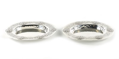 Lot 715 - A PAIR OF LIBERTY & CO. ARTS AND CRAFTS SILVER OVAL DISHES DESIGNED BY BERNARD CUZNER