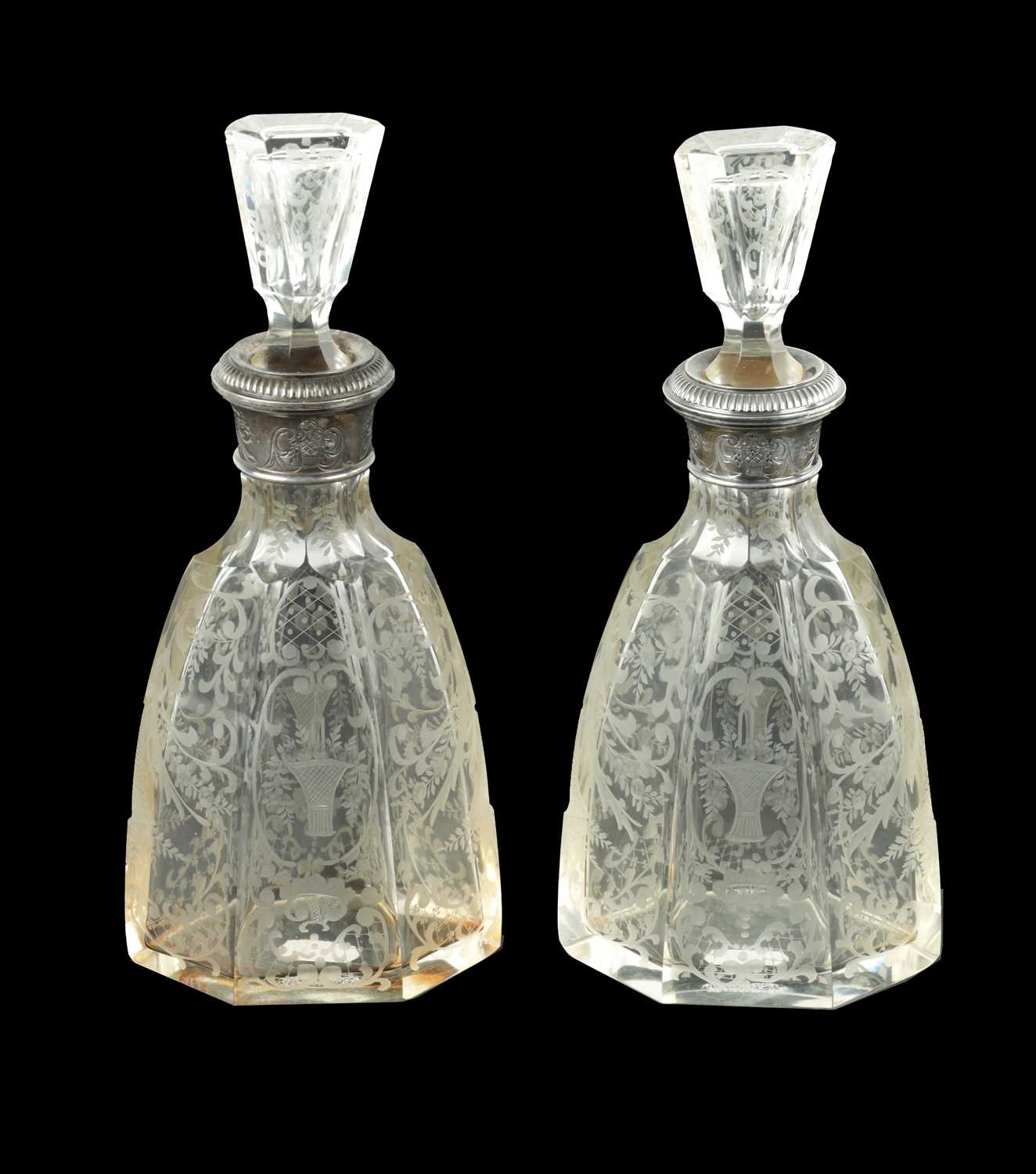 Lot 677 - A NEAR PAIR OF 19TH CENTURY SILVER TOPPED CUT GLASS DECANTERS
