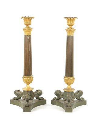 Lot 1038 - A PAIR OF REGENCY BRONZE AND ORMOLU CANDLESTICKS WITH LATER OIL LAMP FITTINGS