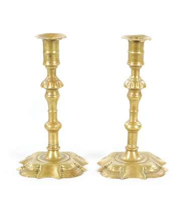 Lot 792 - A PAIR OF MID 18TH CENTURY SEAMED CAST BRASS CANDLESTICKS