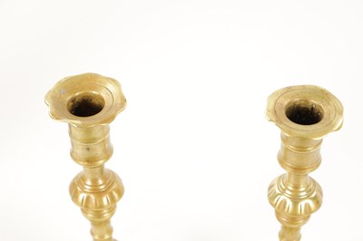 Lot 792 - A PAIR OF MID 18TH CENTURY SEAMED CAST BRASS CANDLESTICKS