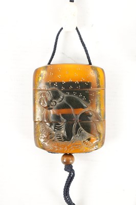 Lot 606 - A 19TH CENTURY JAPANESE CARVED AMBER INRO