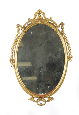 Lot 1457 - AN 18TH CENTURY CARVED GILTWOOD OVAL HANGING MIRROR