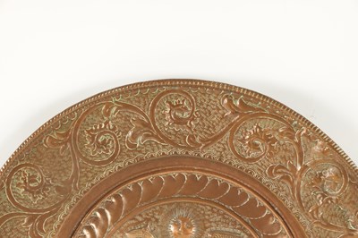 Lot 384 - A 16TH / 17TH CENTURY EMBOSSED COPPER ALMS DISH OF LARGE SIZE