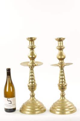 Lot 202 - A LARGE PAIR OF 18TH CENTURY BRASS CANDLESTICKS