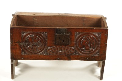 Lot 316 - AN IMPORTANT 17TH CENTURY CARVED OAK PLANK COFFER WITH CARVED ROMANESQUE HEADS