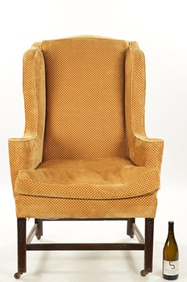 Lot 102 - A GEORGE III STYLE MAHOGANY WING BACK UPHOLSTERED ARMCHAIR