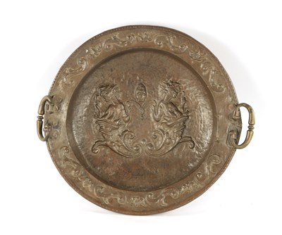 Lot 94 - AN EARLY 18TH CENTURY SPANISH EMBOSSED BRASS TWO HANDLED DISH