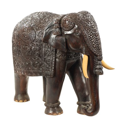 Lot 576 - A LARGE EARLY 20TH CENTURY CARVED HARDWOOD ELEPHANT