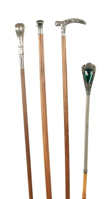 Lot 752 - A COLLECTION OF FOUR LATE 19TH CENTURY SILVER AND WHITE METAL TOPPED WALKING STICKS