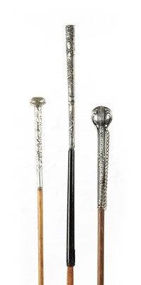 Lot 749 - A COLLECTION OF THREE LATE 19TH CENTURY SILVER TOPPED LONG-HANDLED WALKING STICKS