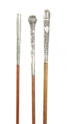 Lot 762 - A COLLECTION OF THREE 19TH CENTURY LONG HANDLED SILVER TOPPED WALKING STICKS