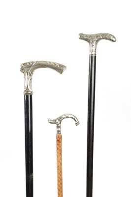 Lot 753 - A COLLECTION OF THREE LATE 19TH CENTURY ART NOUVEAU SILVER TOPPED WALKING STICKS