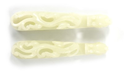 Lot 612 - A PAIR OF LARGE 18TH / 19TH CENTURY CHINESE CARVED WHITE JADE BELT HOOKS