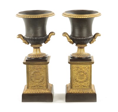 Lot 930 - A PAIR OF 19TH CENTURY BRONZED GILT CAST IRON URNS