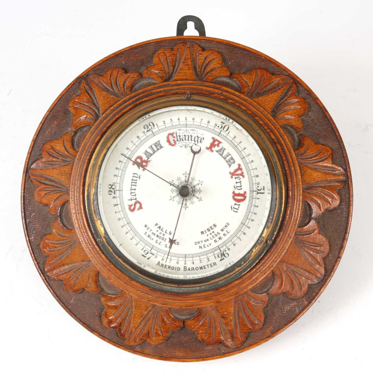 Lot 624 - AN OAK CASE ANEROID BAROMETER with carved