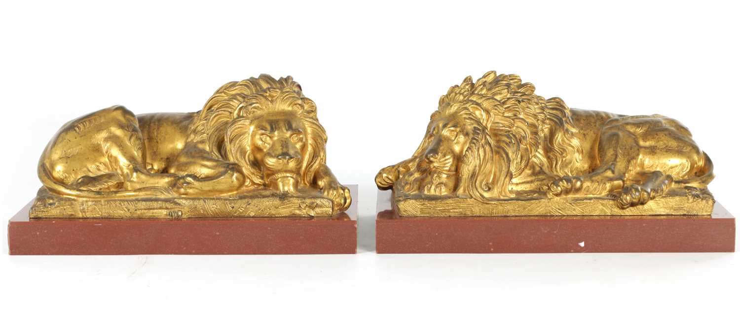 Lot 698 - A PAIR OF LATE 19TH CENTURY GILT BRONZE RECUMBENT LIONS
