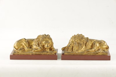 Lot 698 - A PAIR OF LATE 19TH CENTURY GILT BRONZE RECUMBENT LIONS