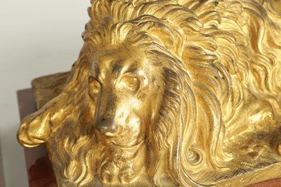 Lot 698 - A PAIR OF LATE 19TH CENTURY GILT BRONZE RECUMBENT LIONS