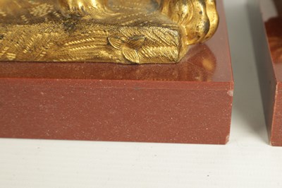 Lot 698 - A PAIR OF LATE 19TH CENTURY GILT BRONZE RECUMBENT LIONS