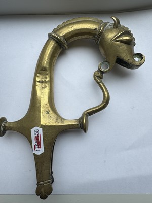 Lot 816 - A 19TH CENTURY INDIAN RAJPUT BRONZE SWORD HILT