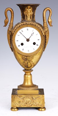 Lot 642 - A FRENCH EMPIRE ORMOLU URN-SHAPED MANTEL CLOCK...