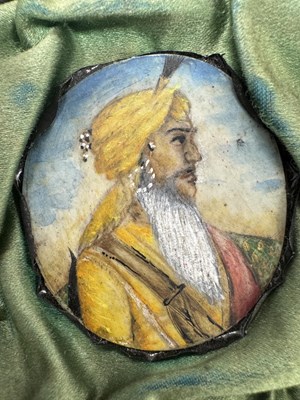 Lot 276 - A CASE GROUP OF NINETEEN PAINTED IVORY MINIATURE PORTRAITS OF THE INDIAN MAHARAJA OF PUNJAB
