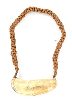 Lot 886 - A LARGE 19TH CENTURY SAILOR SCRIMSHAW WHALE’S TOOTH ON ORIGINAL ROPE SUSPENSION