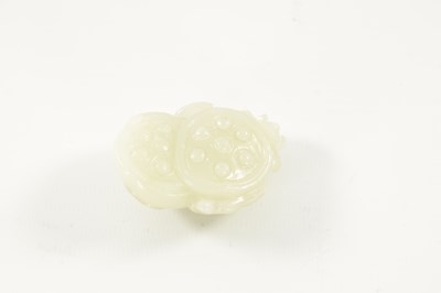 Lot 113 - A 19TH CENTURY CHINESE CARVED WHITE JADE SCULPTURE OF A POMEGRANATE