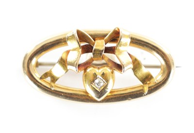 Lot 284 - A 15CT GOLD AND DIAMOND OVAL SHAPED SWEETHEART BROOCH