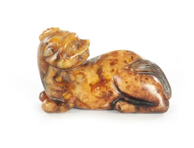 Lot 258 - A CHINESE CARVED RUSSET JADE SCULPTURE OF A RECUMBENT BEAST