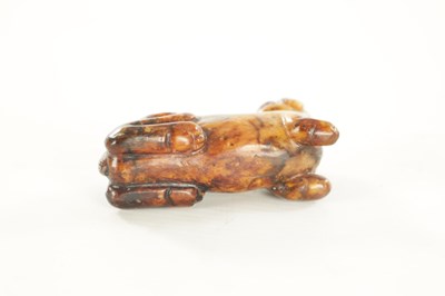 Lot 258 - A CHINESE CARVED RUSSET JADE SCULPTURE OF A RECUMBENT BEAST