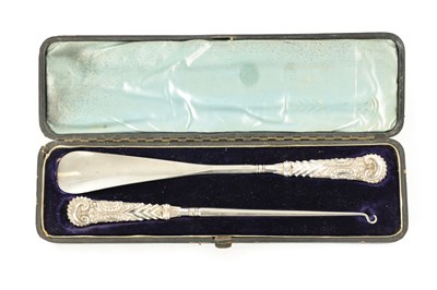 Lot 519 - A CASED SILVER-HANDLED BUTTON HOOK AND SHOE HORN