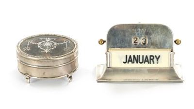 Lot 428 - A GEORGE V SILVER DESK CALENDER AND TORTOISESHELL JEWELLERY BOX