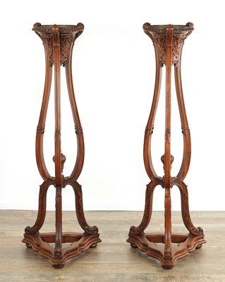 Lot 1511 - A PAIR OF EARLY 20TH CENTURY CHIPPENDALE STYLE CARVED MAHOGANY TORCHERES